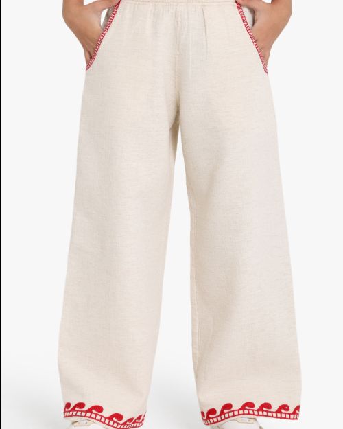 Girls wide-leg beige linen blend pants with red wave embroidery at hem and red stitched pocket detail 4 yrs Front | Locafy