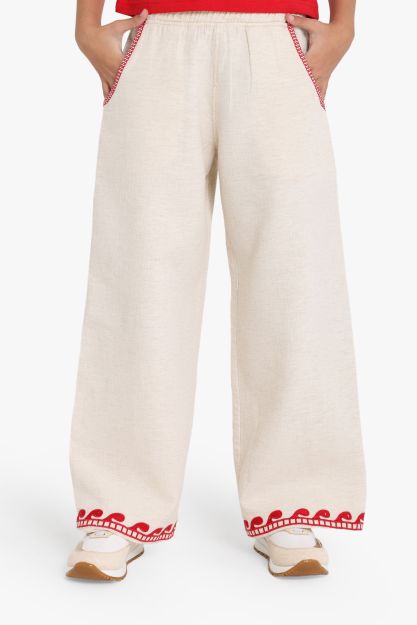Girls wide-leg beige linen blend pants with red wave embroidery at hem and red stitched pocket detail 4 yrs Front | Locafy